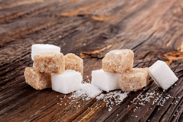 Brown and white crystal sugar cubes. - Photo, Image