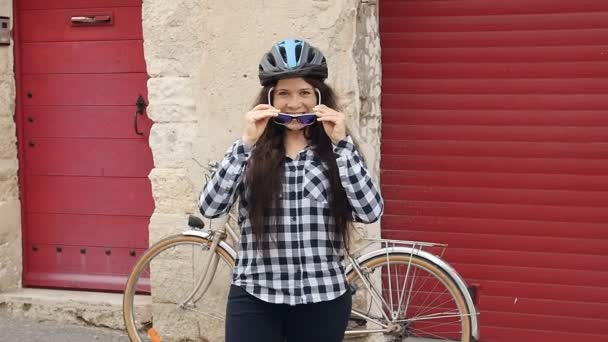 Młoda kobieta z rowerem na danej ulicy miasta - Materiał filmowy, wideo