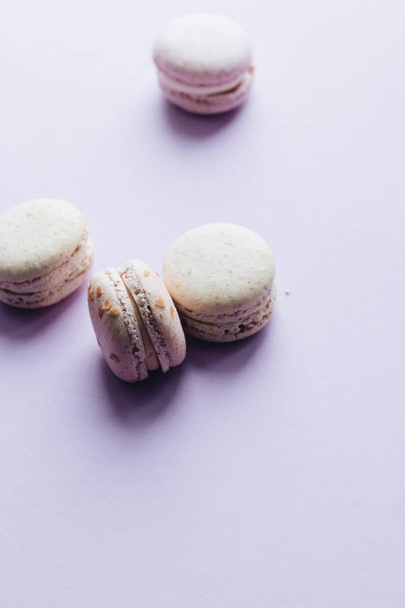 composition of delicious macaroons on purple table, sweet dessert  - Fotoğraf, Görsel