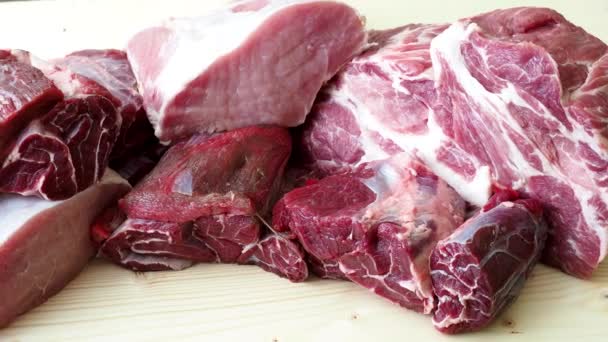 Different types of raw pork meat and beef. Raw meat on wooden table.  - Footage, Video
