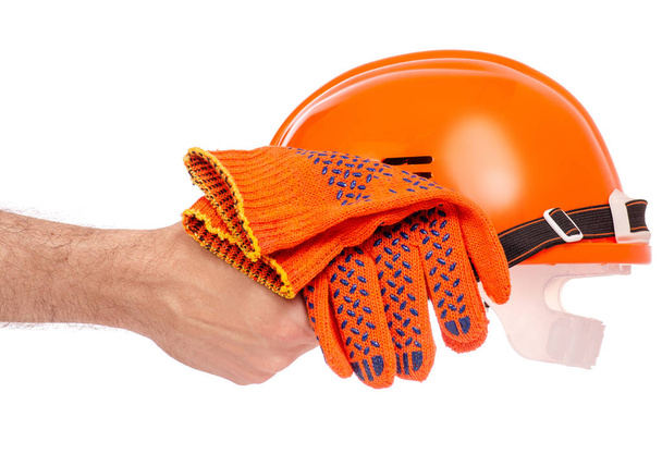 Orange man's helmet man's hand in glove - Foto, Bild