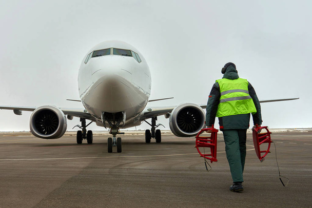 Ground crew meets passenger airplane. Plane in parking. - Photo, Image