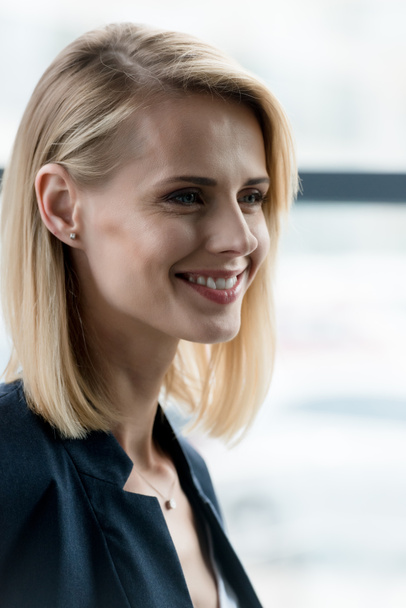 close-up portrait of beautiful smiling blonde woman looking away - Foto, imagen
