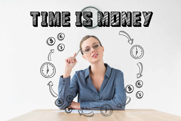 thoughtful businesswoman sitting at table and holding pencil in hand, with time is money inscription and hand drawn business circuit - Photo, Image