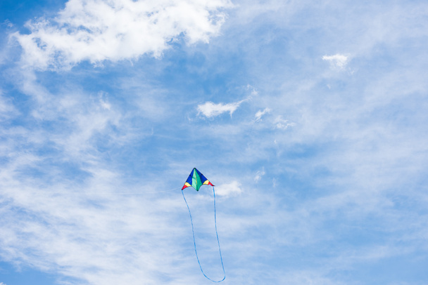 low angle view of kite with cloudy sky on background  - Zdjęcie, obraz