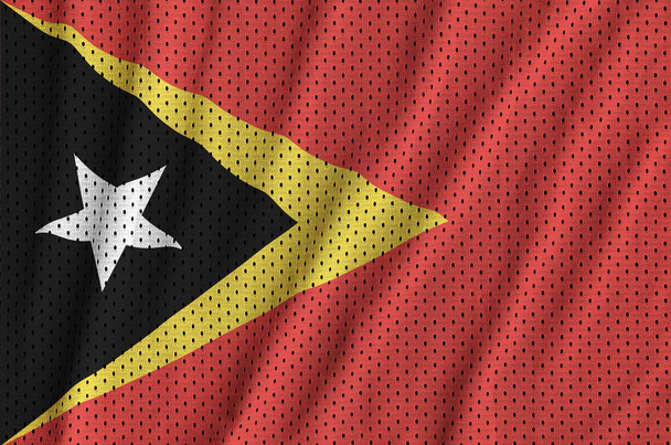 Timor Leste flag printed on a polyester nylon sportswear mesh fabric with some folds - Photo, Image