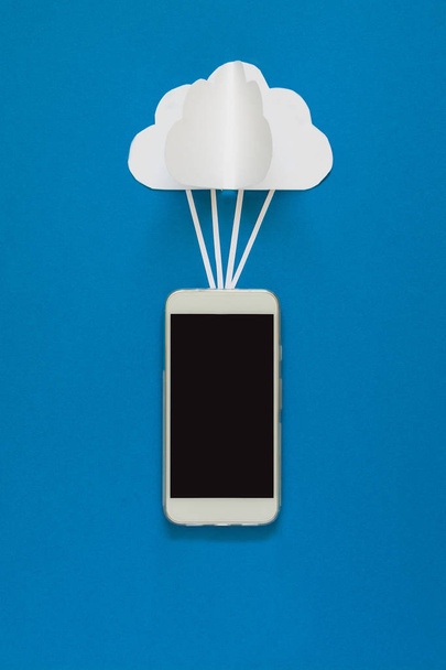 Network connection and cloud storage technology concept. Data communications and cloud computing network concept. Smart phone flying on paper cloud. Origami. Paper cut. Top view - Fotó, kép