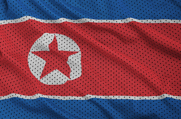 Észak-Korea zászló nyomtatott-ra egy poliészter nylon sportruházat háló fa - Fotó, kép