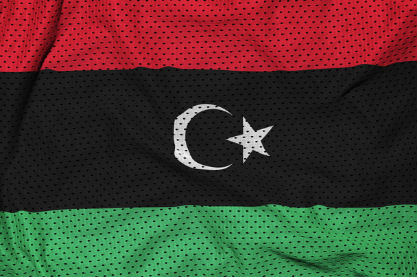 Σημαία της Λιβύης που εκτυπώνονται σε ένα ύφασμα πολυεστέρα νάιλον sportswear ματιών με ορισμένες πτυχές - Φωτογραφία, εικόνα