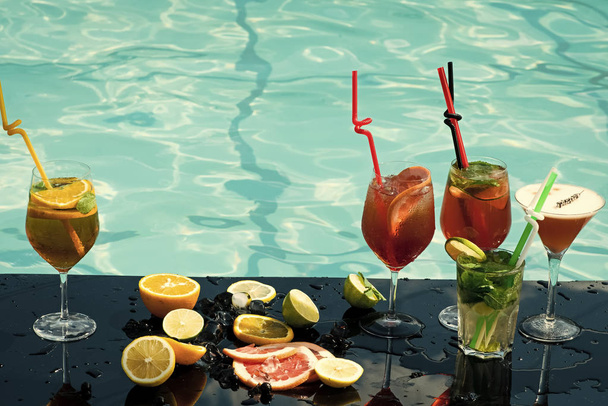 Cocktails at water pool. - 写真・画像
