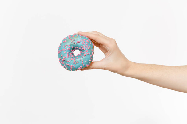 Close up female holds in hand colorful blue donut isolated on white background. Proper nutrition or sweets, dessert fast food, dieting morning concept. Copy space for advertisement. Advertising area. - Foto, Bild