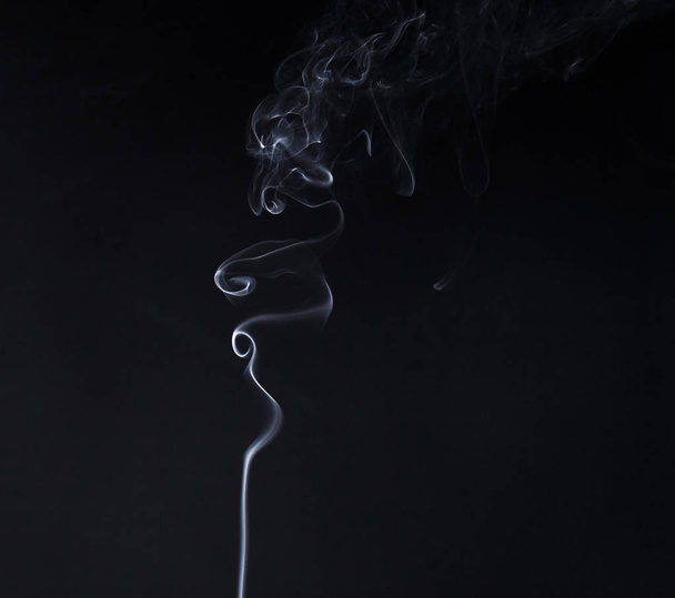 Vertical smoky curve of smoldering aroma stick - Photo, Image