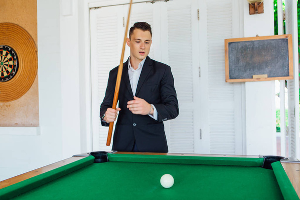 Young handsome man playing billiard game alone - Valokuva, kuva
