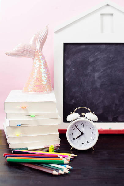 School supplies and alarm clock on table. Back to school concept. - Foto, immagini