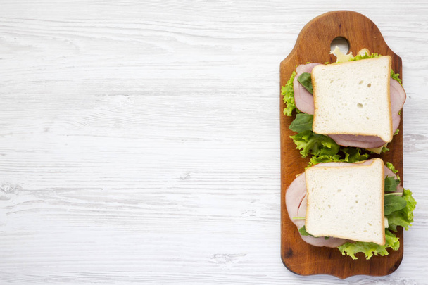 Ready-made sandwiches on a wooden board, top view. Copy space. - Foto, Imagem