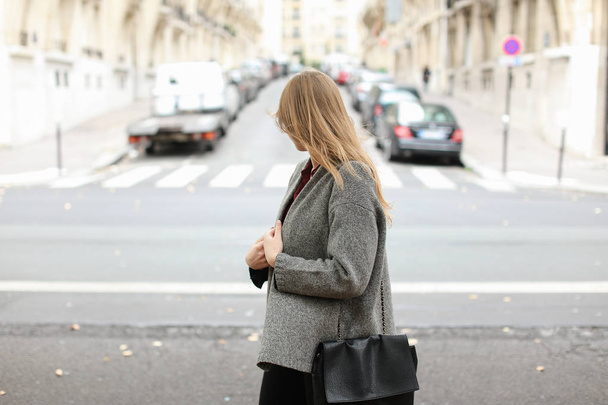 Blonde female student walking on street near cars in city. - Valokuva, kuva