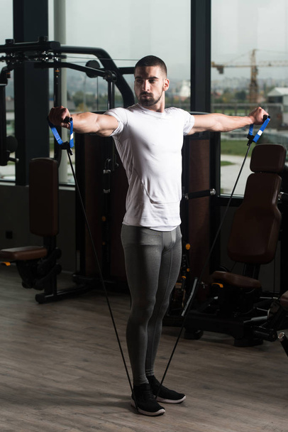 Athlete Exercising Shoulders With Pull Rope Elastic Cable - Fotó, kép