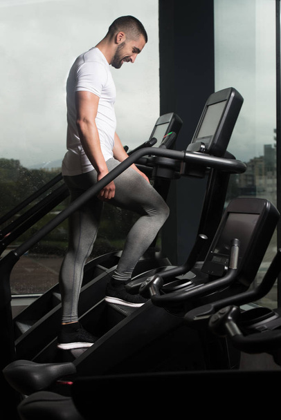 Young Man Exercising On A Stepper - Foto, imagen