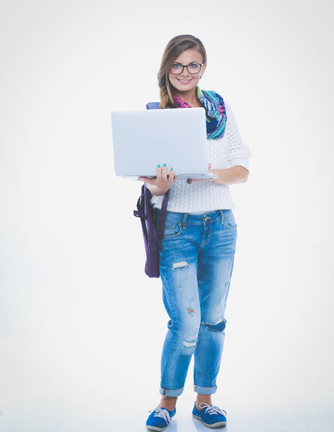Smiling teenager with laptop on white background. Student. - Foto, afbeelding