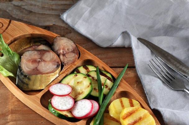 smoked mackerel, fried zucchini and potatoes  - Фото, изображение
