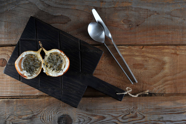 Granadilla or grenadia passionfruit on wooden rustic background - Photo, image