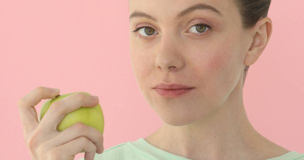 Young woman is eating an apple Healthy nutrition - 写真・画像