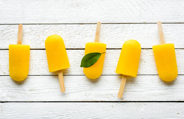 Orange popsicles with juice. Ice pops, flat lay, top view - 写真・画像