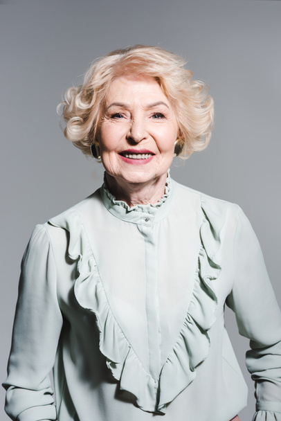 close-up portrait of smiling senior woman isolated on grey - Zdjęcie, obraz