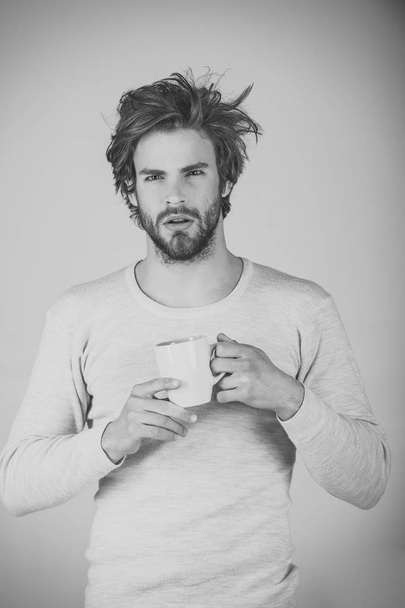 Man with disheveled hair drink mulled wine. - 写真・画像