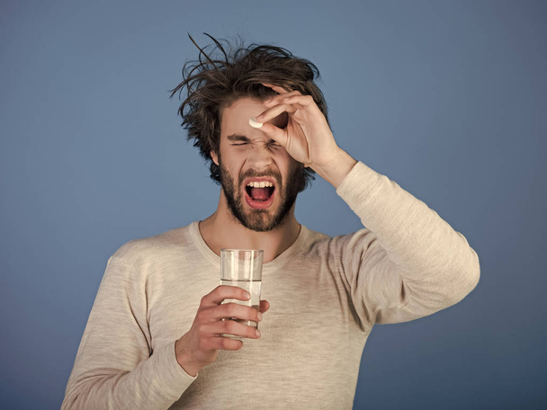 Man drink pill with water, illness, insomnia. - Fotó, kép