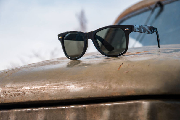 Sunglasses in an old military car, spring day - Valokuva, kuva