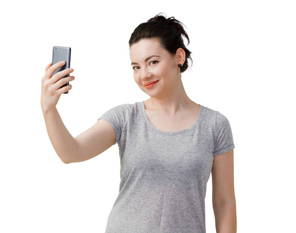 Image of young asian woman standing isolated over dark grey wall background looking aside make selfie by smartphone. - Foto, imagen