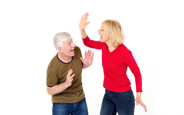 Wife screams and hits her husband. An adult couple, a man and a woman, of middle age. - Photo, Image