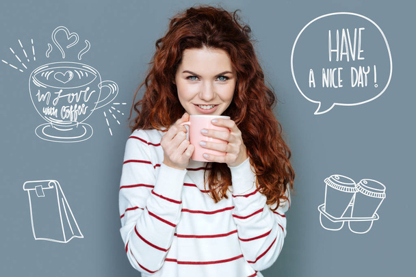 Cheerful secretary looking relaxed while drinking hot coffee - Photo, Image
