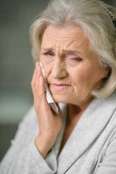 Senior woman with toothache, close up view  - Foto, afbeelding