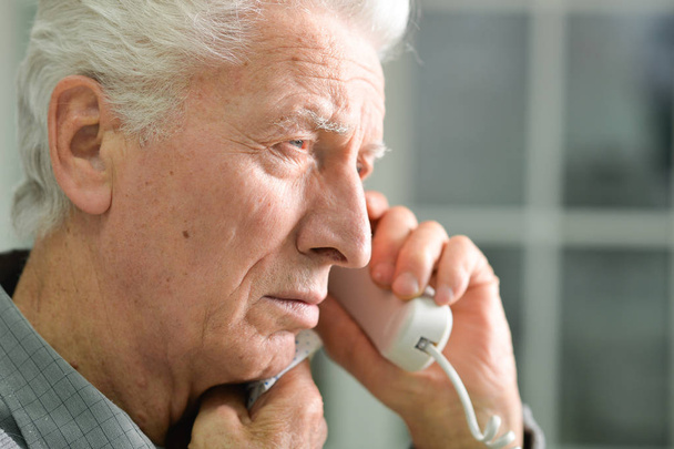 Elderly ill man calling doctor - Фото, изображение