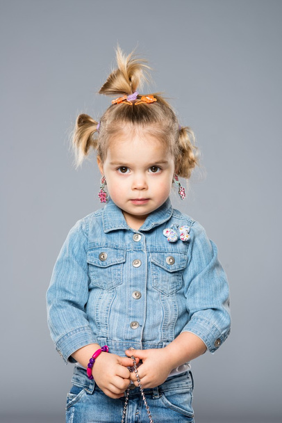 Funny little girl isolated on grey - Valokuva, kuva