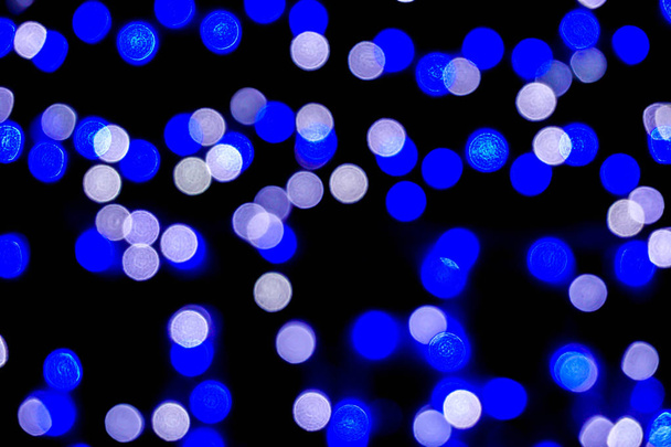 Closeup blue abstract blurred and bokeh of LED party light bubs reflection lighting at night time. - Photo, Image
