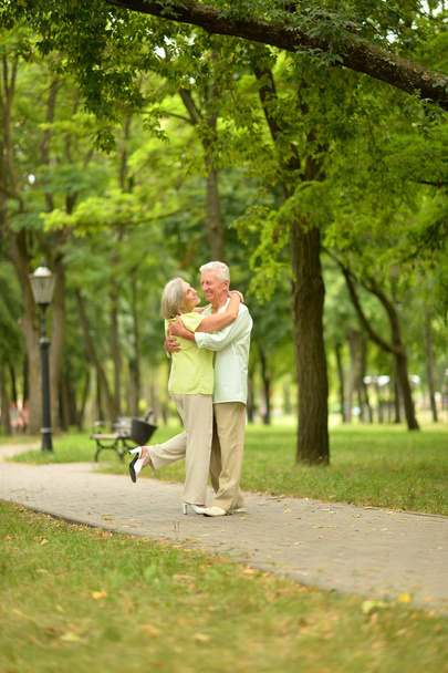 Happy senior couple hugging  in park  outdoors - Zdjęcie, obraz