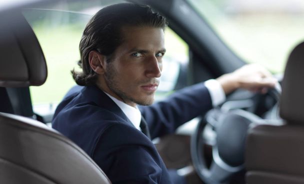 man sitting behind the wheel of a car - Zdjęcie, obraz