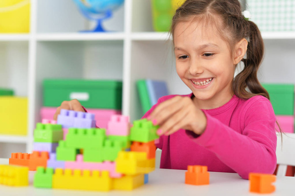 Cute girl playing with plastic blocks - Photo, image