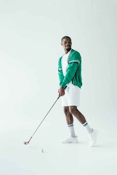 african american golfer in vintage sportswear playing game, isolated on white - Fotografie, Obrázek