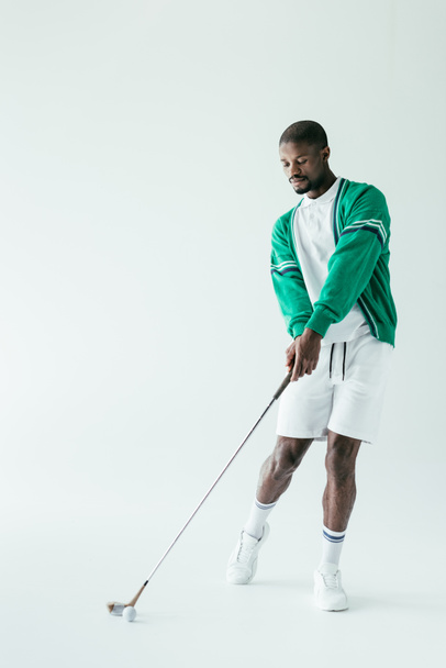 fashionable african american man playing golf, isolated on white - Фото, зображення
