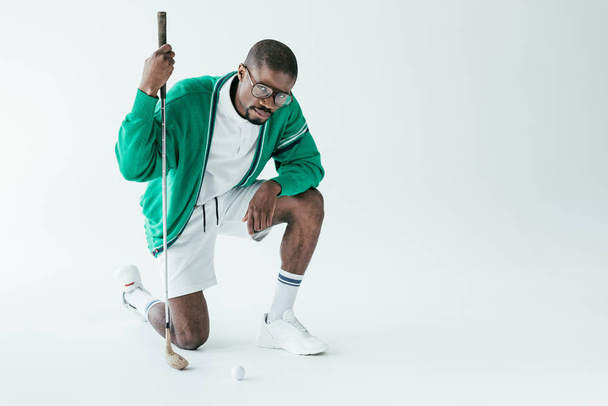 fashionable african american golfer in vintage sportswear, isolated on white - 写真・画像