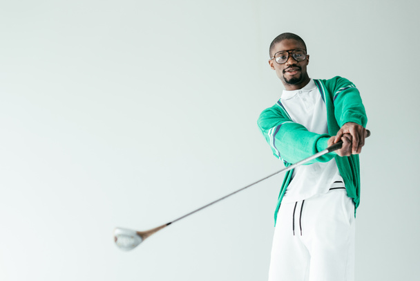 stylish african american man in retro sportswear playing golf, isolated on white - Foto, immagini