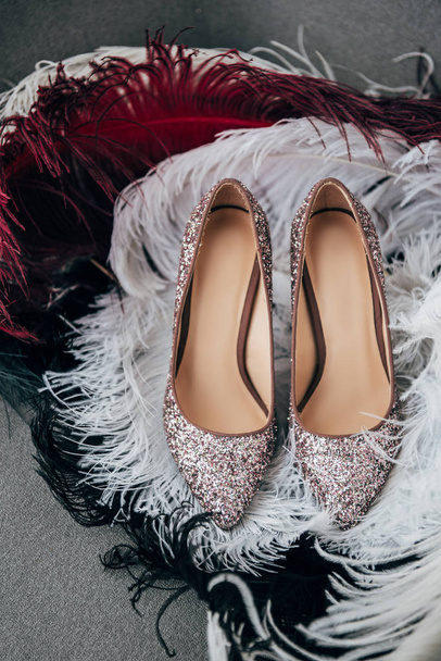 close up view of bridal shoes and decorative feathers for rustic wedding on armchair - 写真・画像