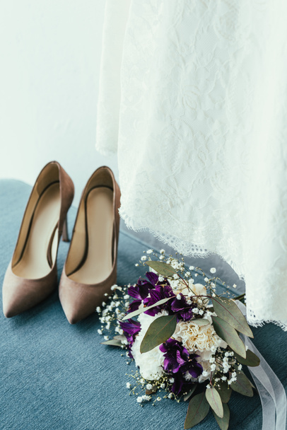 close up view of bridal shoes, wedding bouquet and dress for rustic wedding - Foto, imagen
