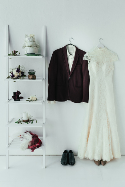 close up view of bridal and grooms clothing and accessories for rustic wedding in room - Foto, Imagen