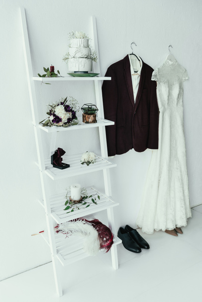 close up view of bridal and grooms clothing and accessories for rustic wedding in room - Foto, Imagen