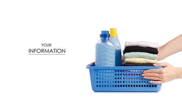 Stack of clothes in a plastic basket Liquid powder conditioner fabric softener in hand pattern - Photo, Image
